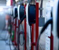 Electric car charging station for charge EV battery. Plug for electric vehicle. EV charger. Charging point at car parking lot of the mall. Clean and sustainable energy. Commercial EV charging point.